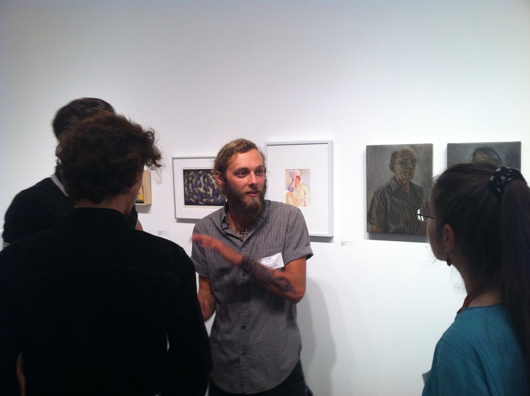 Cody talking at art gallery